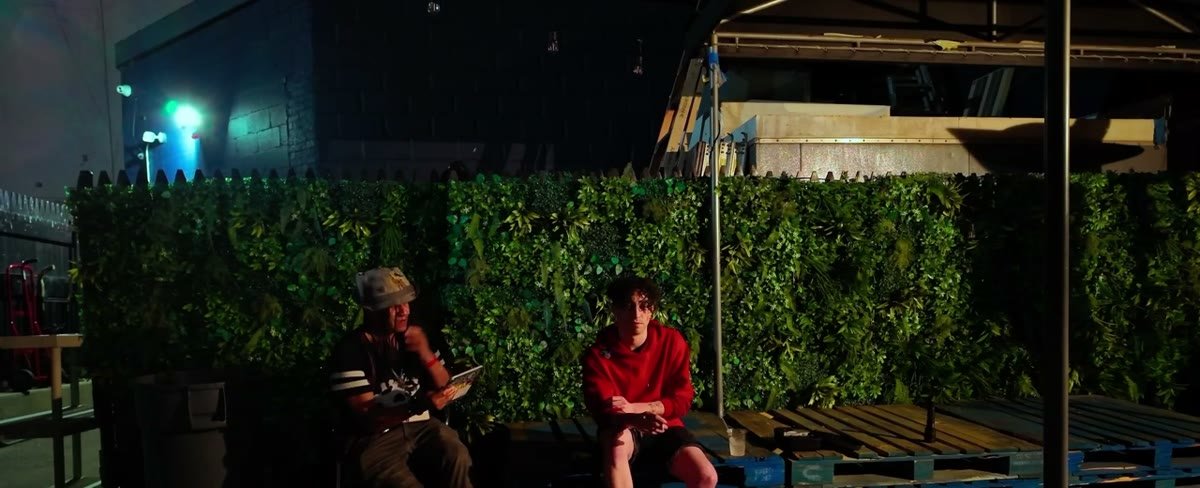 Two people talking on a rooftop terrace during the Blue interview